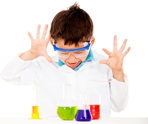 Boy doing chemical experiments at the lab - isolated over white