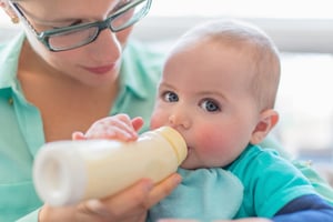 Cute baby brinking from a bottle