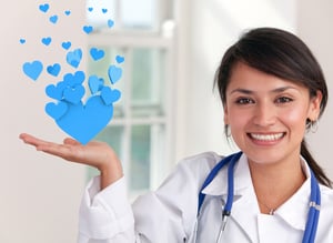 Female doctor holding hearts at the hospital and smiling