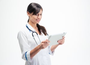 Smiling medical doctor using tablet computer isolated on a white background