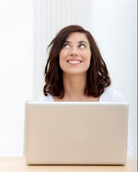 Thoughtful woman working on a laptop at home-1-1