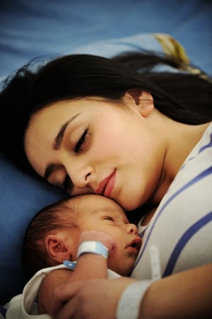 Woman holding her 2 days old newborn baby