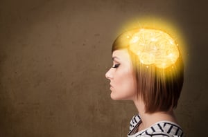 Young girl thinking with glowing brain illustration on grungy background